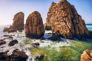 Ursa beach, Sintra, Portugal. Epic sea stack rocks rising from atlantic ocean in sunset light. Ursa beach, Sintra, Portugal. Epic sea stack rocks rising from atlantic ocean in sunset light.